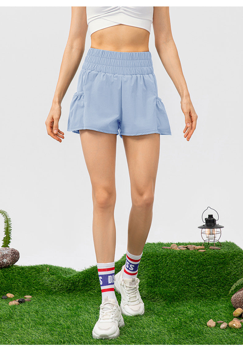 Group of confident women in premium activewear leggings and sports bras, moving gracefully in a bright, stylish studio setting.